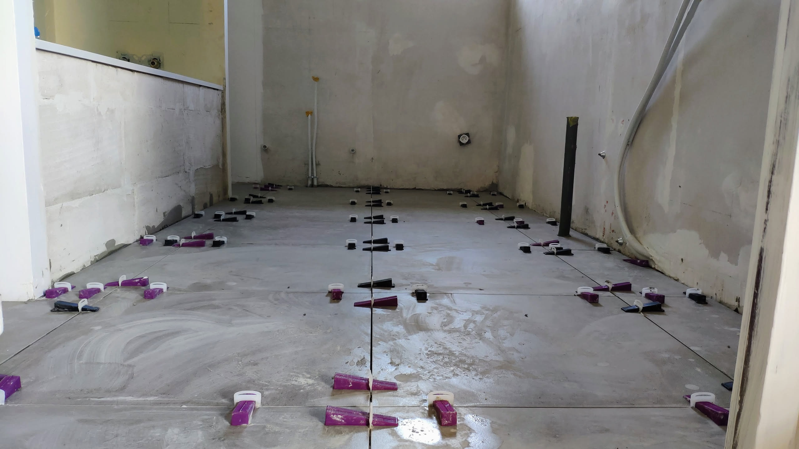 Carrelage du sol en cours avec cales de nivellement